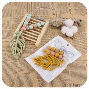 Baby silicone teething necklace set with leaf pendants and wooden beads on grey rope