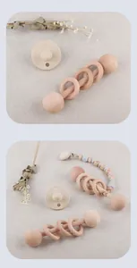 Detail of wooden baby rattle and pacifier chain with gray silicone beads on linen fabric