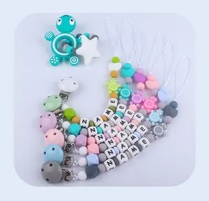 Detail view of macaron silicone baby pacifier clips with turtle teether and custom name beads