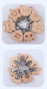 Detail of wooden baby pacifier clips in animal shapes and stainless steel clips