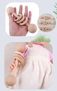 Detail view of smooth beech wood baby rattle with three moving rings and natural texture