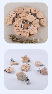 Detail of wooden baby pacifier clips featuring heart shape with I love Mom engraving