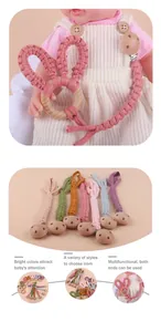 Detail of DIY baby beech wood teether rings with colorful handmade cotton bunny ears
