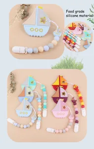 Macro detail of sailboat teething set with food-grade silicone beads and pacifier clip