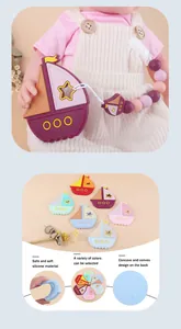 Detail of sailboat silicone baby teether with textured back and beaded pacifier clip