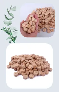 Detail of 15mm beech wood alphabet beads being held, ideal for DIY pacifier chains