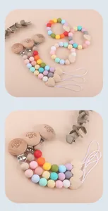 Close-up of wooden baby pacifier clip with LOVE engraving and silicone teething beads