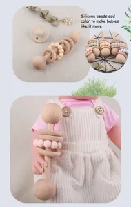 Detail of baby wooden rattle with colorful silicone beads and beech wood rings for teething