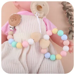 Handmade silicone and wooden baby pacifier clip and teether set with heart wood bead