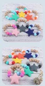 Close-up of beech wood beads and silicone star teether toy for infant sensory relief