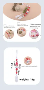 Detail of Christmas baby pacifier clip showing festive beads and silicone snowman charm