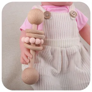 Baby wooden rattle with pink silicone beads and beechwood rings for teething and grasping