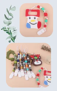Detail of Christmas silicone teether clips with snowman and tree beads on blue background
