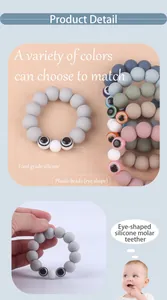 Detail of food-grade silicone baby teether with colorful beads and eye-shaped accents