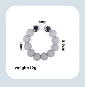Detailed view of grey silicone baby teether beads with eye motifs and size dimensions