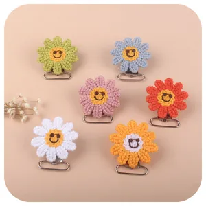 Handmade crochet sunflower pacifier clips in six vibrant colors with cute smiley face motifs