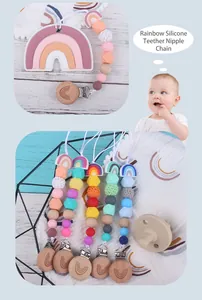 Macro view of rainbow silicone pacifier clips with colorful beads and beech wood details