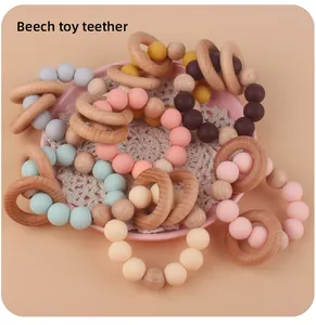 Macro detail of baby teether bracelet with beech wood ring and macaron silicone beads