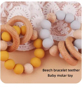 Detail of beech wood and silicone baby molar teether bracelet for infant grasping