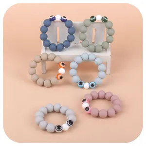 Silicone bead baby teething rings with evil eye charms in six assorted pastel colors