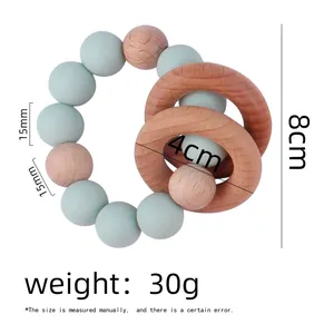 Detailed view of baby teether rattle with 15mm mint silicone beads and 4cm wooden rings