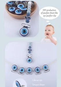 Close-up of DIY baby pacifier clip featuring blue evil eye resin charm and silicone beads