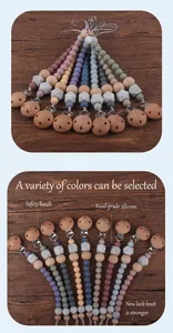 Detail of beech wood pacifier clip and multi-color silicone beads for baby use