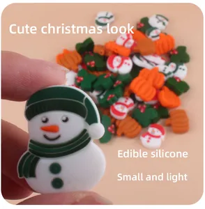 Close-up of small Christmas silicone beads featuring snowman and pumpkin for DIY pacifier clips