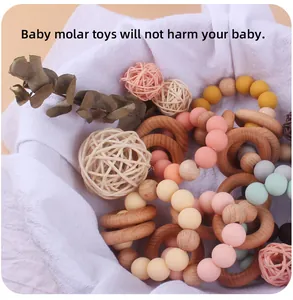 Detail of natural wood and pastel silicone beads teething ring for infant sensory play