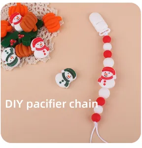 Macro view of Christmas silicone beads and DIY pacifier clip with snowman charms