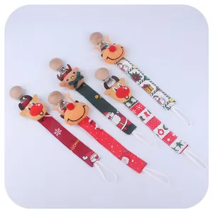 Christmas elk and Santa pacifier clips with plush elk, snowflake, and festive ribbon patterns