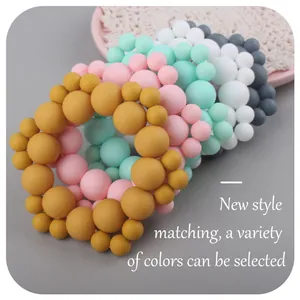 Multi-colored silicone baby teething rings with matte beads in minimalist style