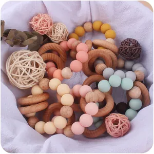 Baby teething ring set with natural wood and colorful silicone beads in a gift basket
