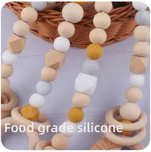 Close-up of food grade silicone and beech wood beads on a baby teething toy