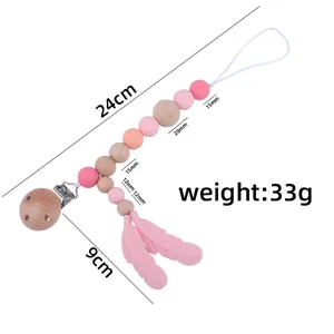 Beech wood and silicone baby pacifier clip with pink feather charms and size specs