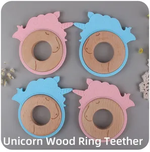Close-up of unicorn silicone teether with natural wooden rings in pink and blue colors