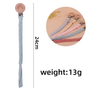 Detail showing 24cm hand-woven pacifier clips in various colors and rainbow wood clip