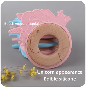 Detail of pink unicorn teether with beech wood ring and edible silicone texture