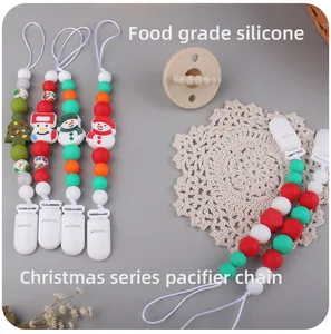 Detailed view of Christmas themed silicone pacifier chain with tree and snowman beads