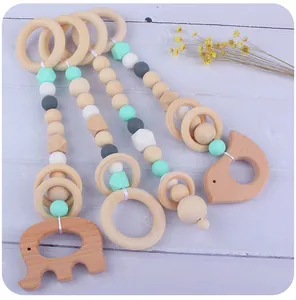 Detail of beech wood elephant and hedgehog teething pendants with silicone beads
