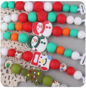 Detailed view of Christmas themed silicone pacifier clip with snowman and tree beads