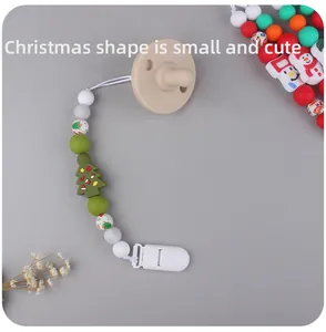 Detail of Christmas silicone pacifier clip with green tree pendant and colorful beads