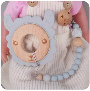 Detail of baby teething set with wooden sheep ring and gray silicone pacifier clip