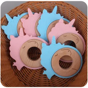 Detail of wooden unicorn baby teethers with colorful silicone in a woven basket