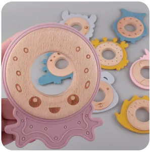 Close-up of wooden baby teether featuring assorted animal-shaped food-grade silicone covers