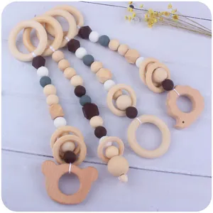 Beech wood and silicone baby teething toy set with wooden animals on a wood background