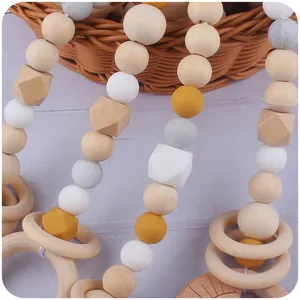 Nordic style baby beech wood teether with colorful silicone beads and a wooden ring toy