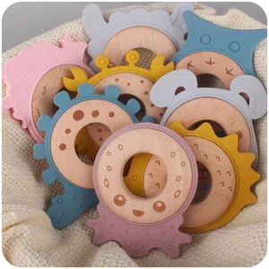 Baby wooden beech ring teether set with colorful silicone animal shapes in a knit basket