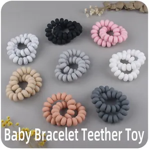 Macro shot of multi-color spiral silicone baby teether bracelets in a neat grid display