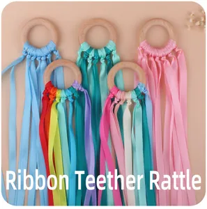 Detailed set of baby ribbon teether rattles with natural beech wood rings and satin ribbons